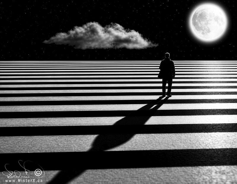 This black-and-white digital composite depicts a lone individual standing on a surreal landscape defined by alternating wide horizontal black and white stripes that stretch to a flat horizon. The person, viewed from behind, casts a long, distorted shadow forward into the foreground across the striped ground. Above the horizon lies a dark, starry night sky featuring a single, elongated cloud floating to the left and a large, glowing full moon positioned on the right.